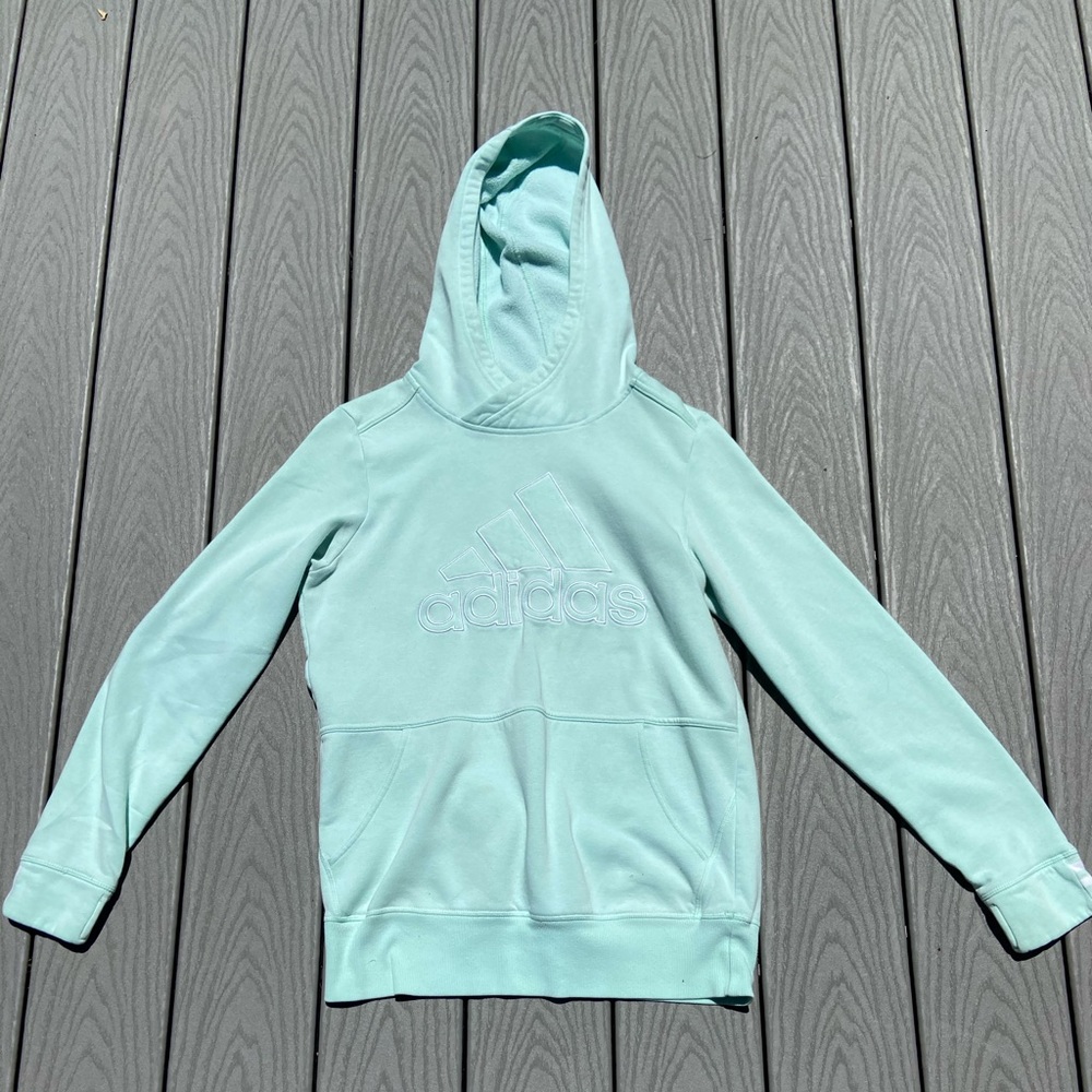 Light blue Adidas sweatshirt.
